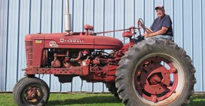 George Monis from Oconomowoc, Wis., sits on 1954 Super M-TA tractor