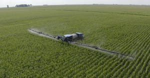 aerial view of sprayer in cornfield