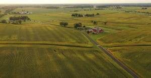 Aerial view of farmstead and fields during growing season.