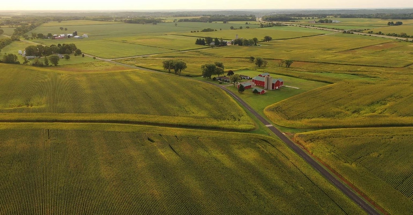 Aerial view of farmstead and fields during growing season.