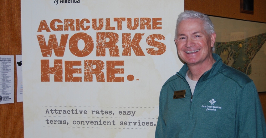 Doug Burns with FCSAmerica next to 'Agriculture works here' sign