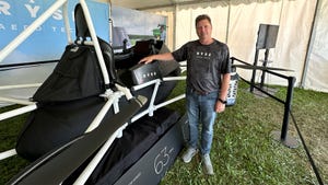 Mick Kowitz poses next to flying ATV