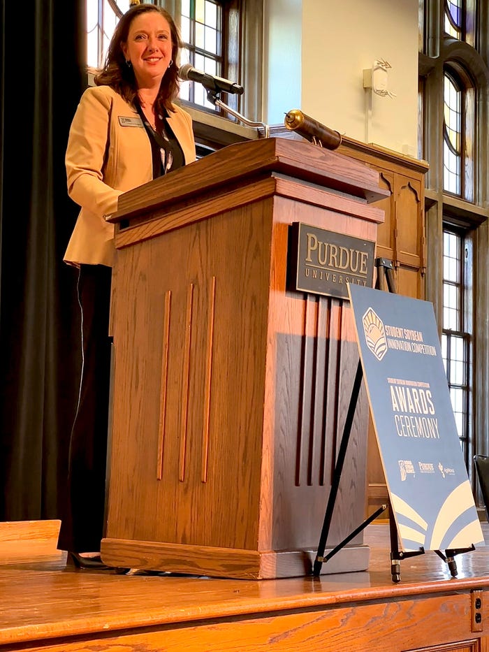 Courtney Kingery standing at a podium Courtney Kingery standing at a podium