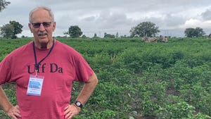 Darrell Boone stands in a farm field in India