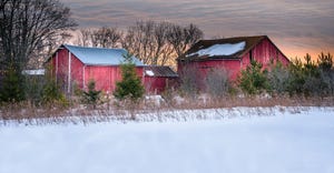 red barns in winter scene
