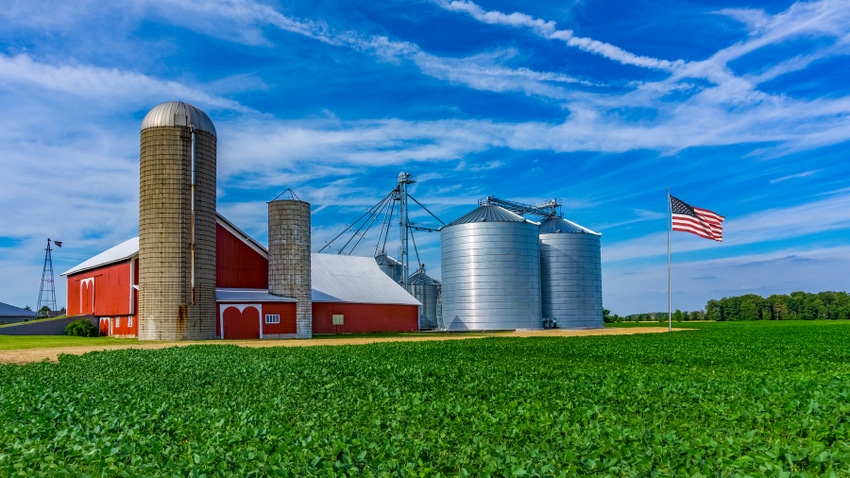 Barn, silos and American flag on flagpole