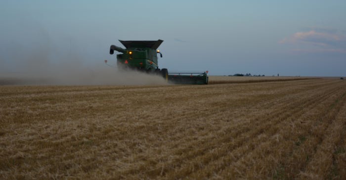 A Hoffman Harvesting combine rolls through a field of wheat on the Vance Ehmke farm in Lane County