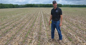 Steve Gauck standing in newly emerged cornfield