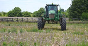 sprayer applying herbicide in field for weed control