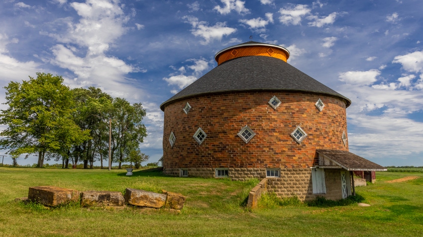 round barn with large stones near entrance