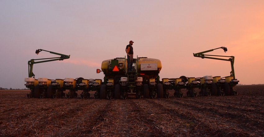 Matt Boucher standing on a planter at sunset