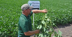 Jason Webster holding soybean plants
