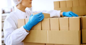 worker with boxes at packaging plant