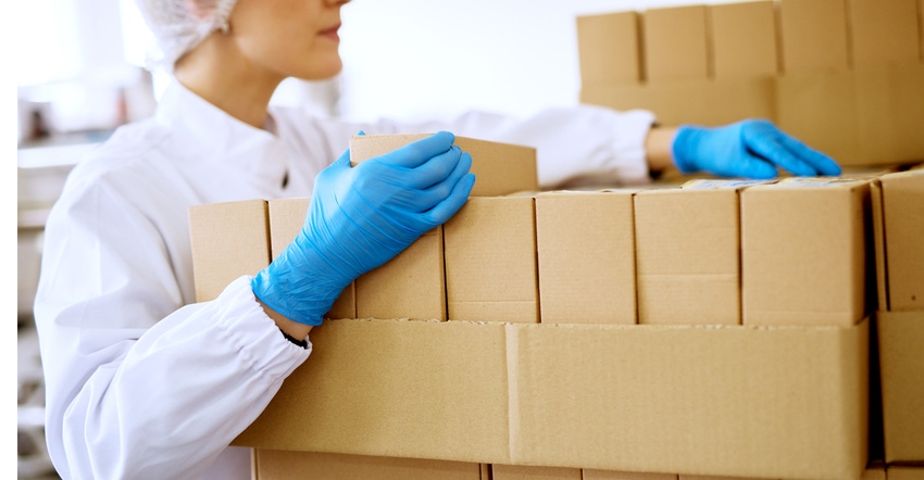 worker with boxes at packaging plant worker with boxes at packaging plant
