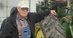 Steve Just stands next to a John Deere 2510 Hi-Crop — one of many John Deere Hi-Crops in his collection