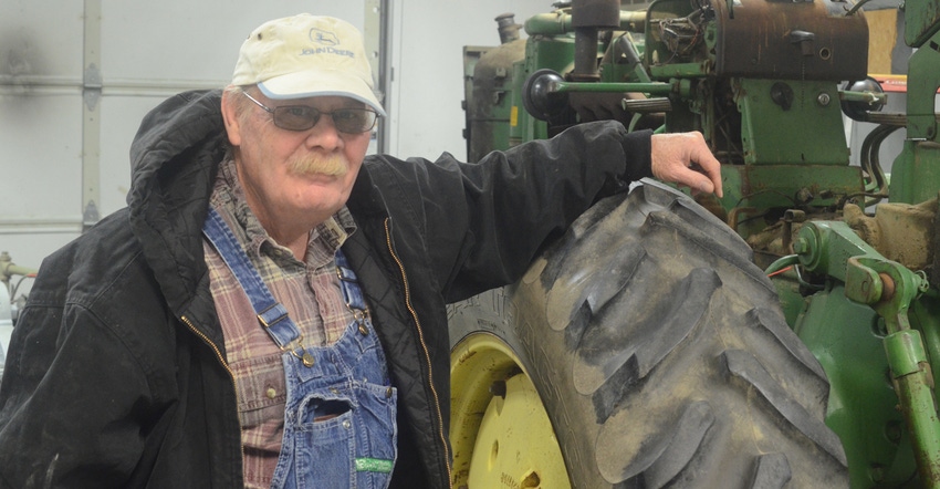 Steve Just stands next to a John Deere 2510 Hi-Crop — one of many John Deere Hi-Crops in his collection