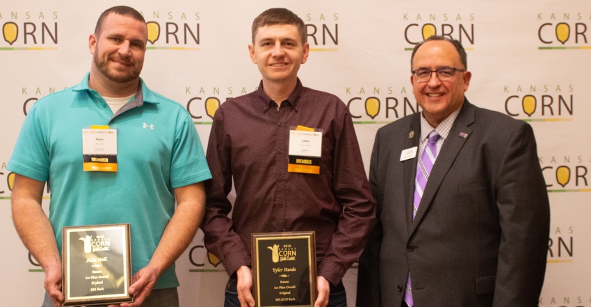 Kansas Corn Yield Contest winners are Alex Noll, left, and Tyler Hands. They are shown with Kansas Corn chief executive Greg 
