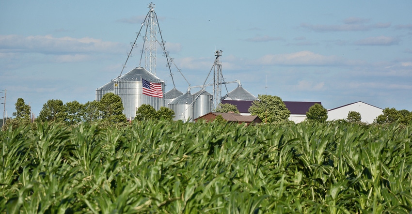  American flag, corn field, bins
