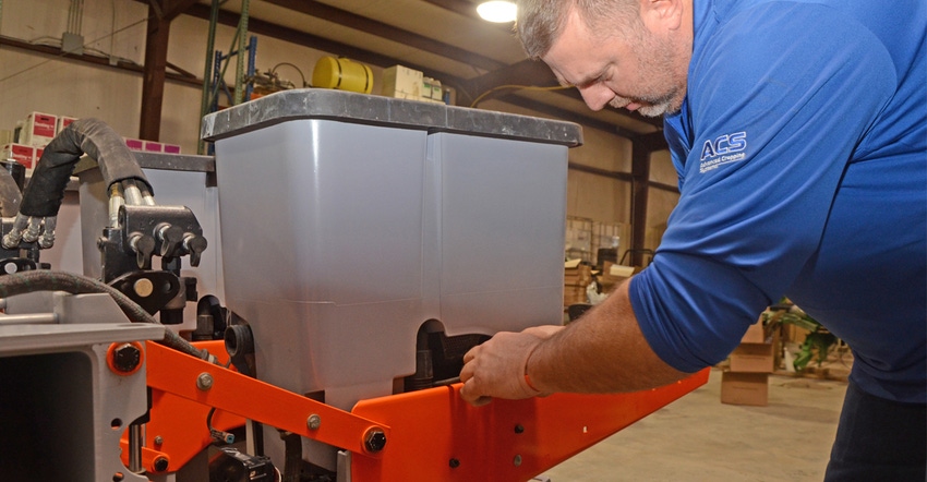 : Advanced Cropping Systems innovation agronomist Mick Goedeken installs a seed box on Central Valley Ag's revamped multi-hyb