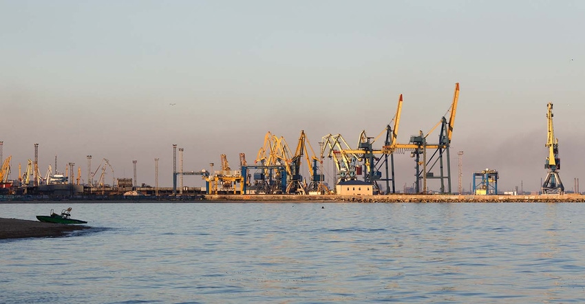 Many big cranes silhouette in the sea port of Azov