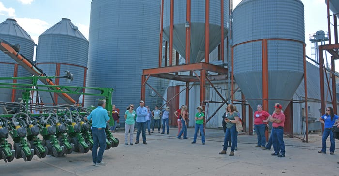 group of people standing in front of grain center