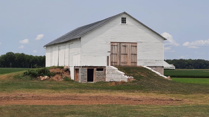 A restored transverse barn with a wagon entrance