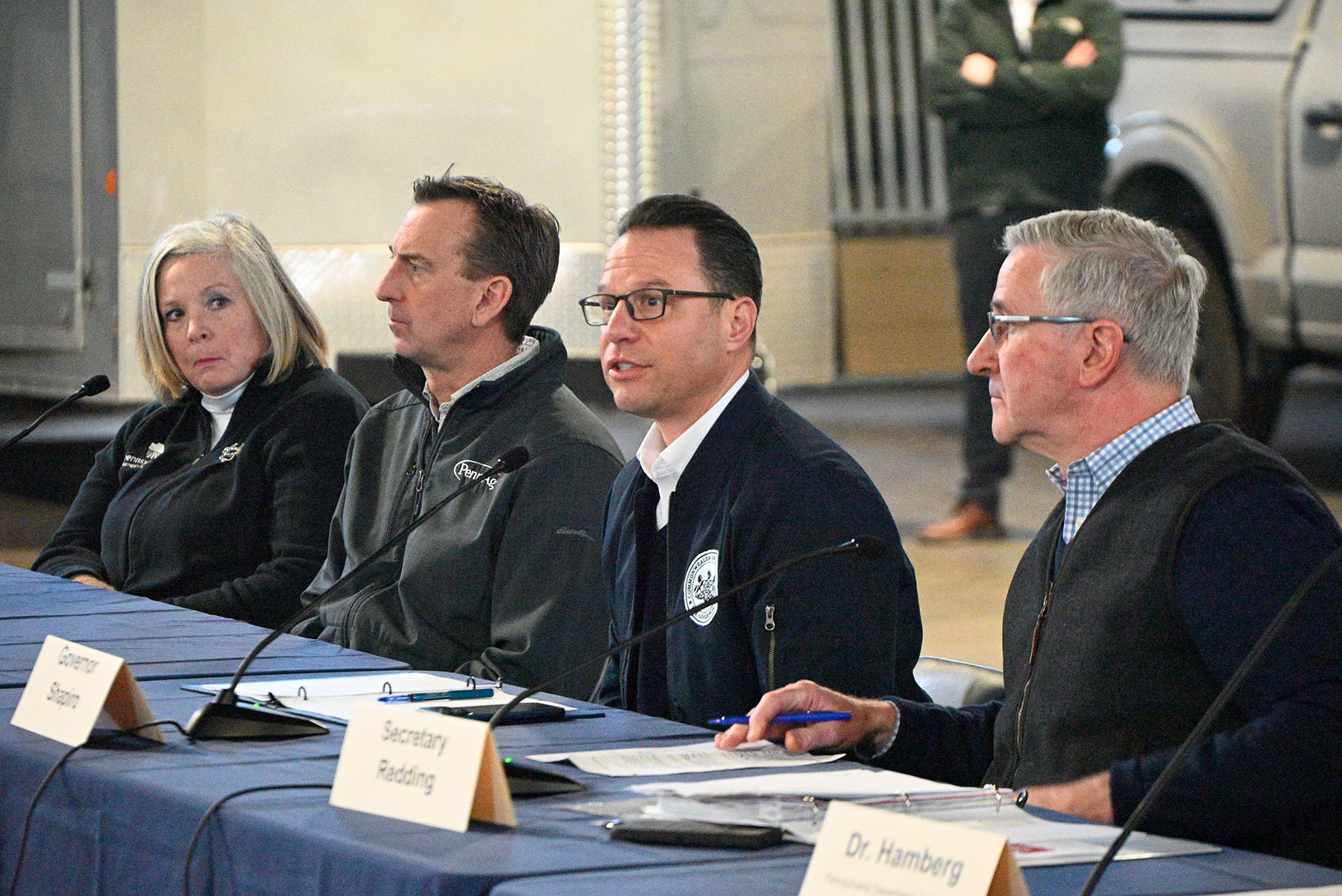 Chris Torres - People sitting at a table with micrphones