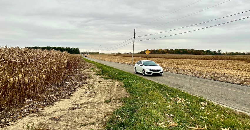 car driving through rural farm area