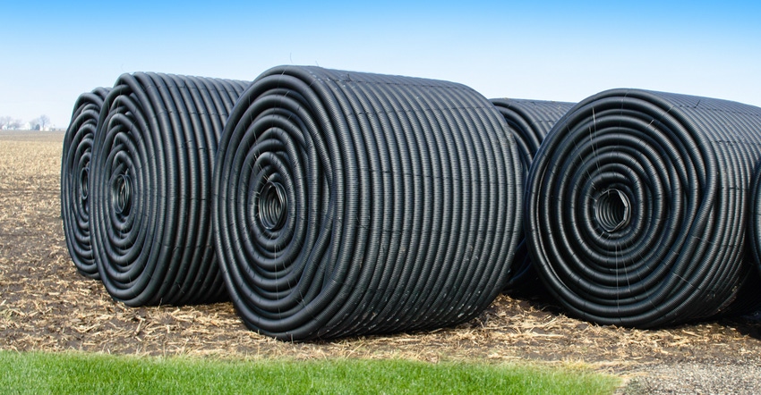 Rolls of tubing in a farm field used for irrigation and drainage
