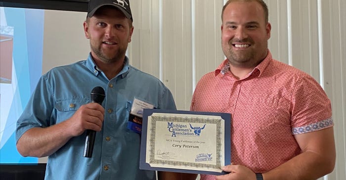 Seth Latimore presents Cory Peterson with his Young Cattlemen of the Year award