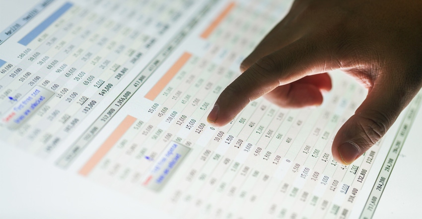 hand pointing to a spread sheet on computer screen