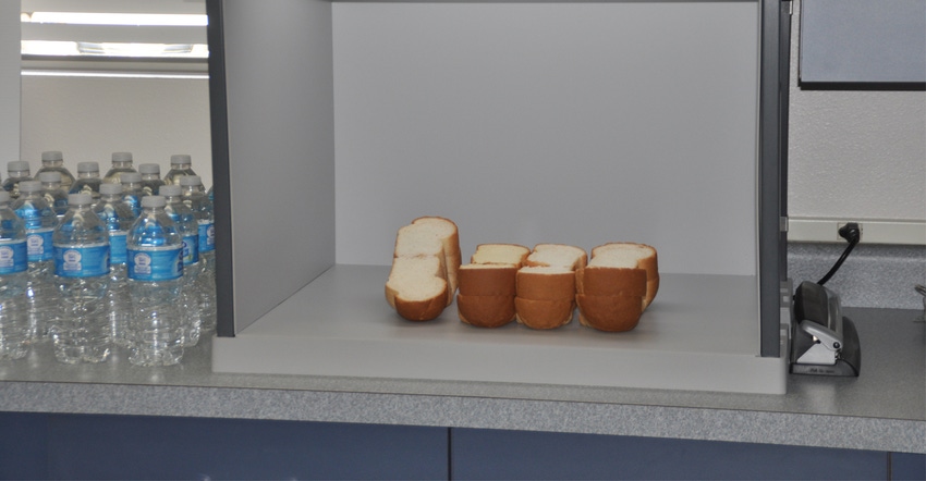 cut bread and water on counter in office