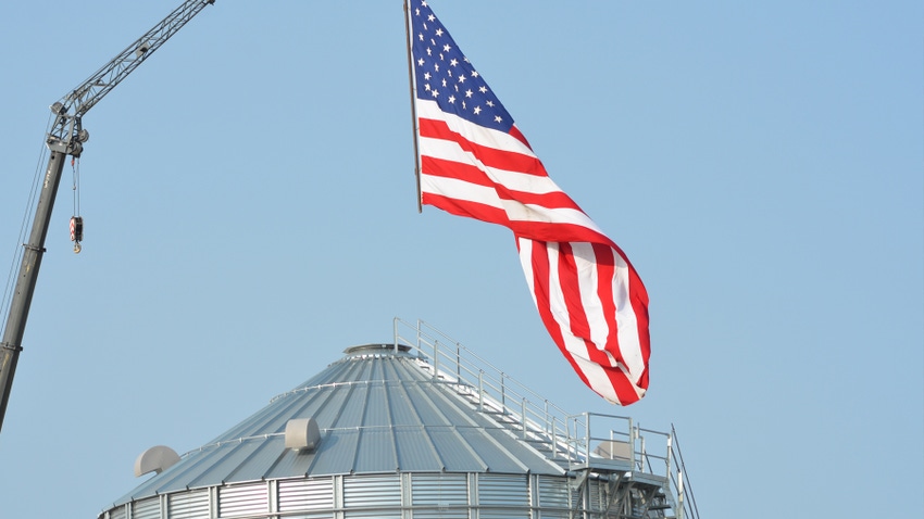 american flag on top of grain silo