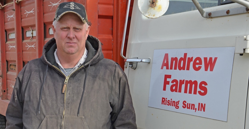 Mike Andrew stands next to farm truck