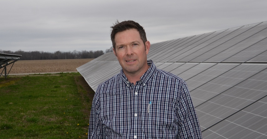 David Hardin standing in front of solar panels