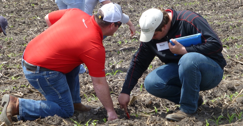 farmers in field taking soil samples