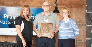 Holly Spangler and Joseph S. Pickrell receiving the Master Farmer award