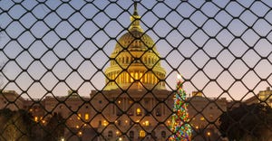 Sunrise over the United States Capitol Building and the Capitol Christmas Tree, now fenced off from the public during the gov