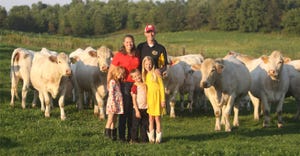 Katie and Jonathon Wantoch with children Gabriella, Broderik and Dalila stand in front of cattle on their farm near Colfax, W