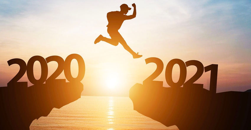 Silhouette man jump from 2020 to 2021 on cliff with sunlight for change and welcome the new year.