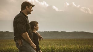 Father and son in field