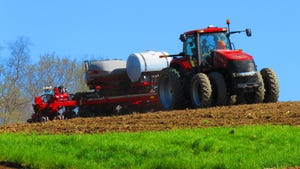tractor and planter equipment at Stuchal Farms head across the fields to plant the 2022 corn crop