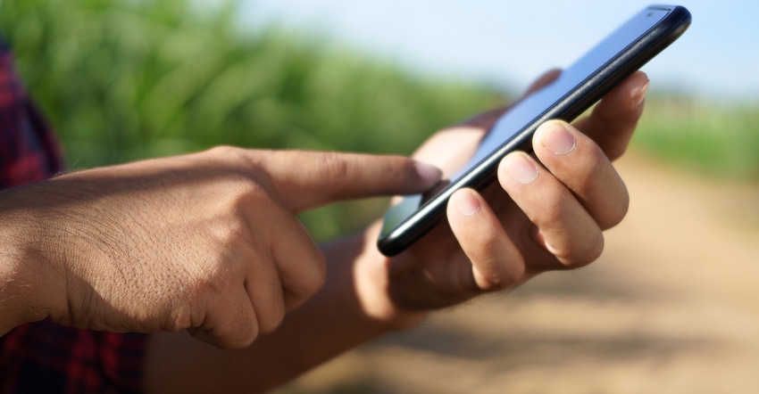 Farmer holding smartphone Farmer holding smartphone