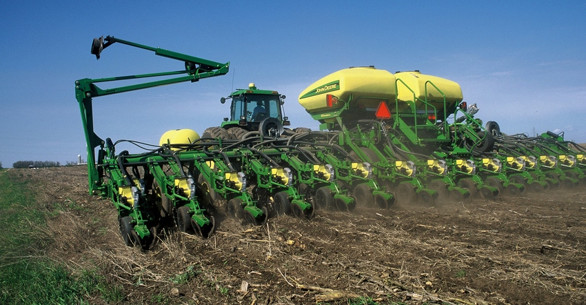 John Deere planter driving through field