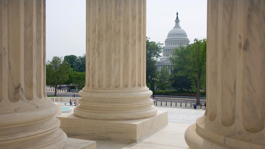 Building column in foreground, U.S. Capitol in background