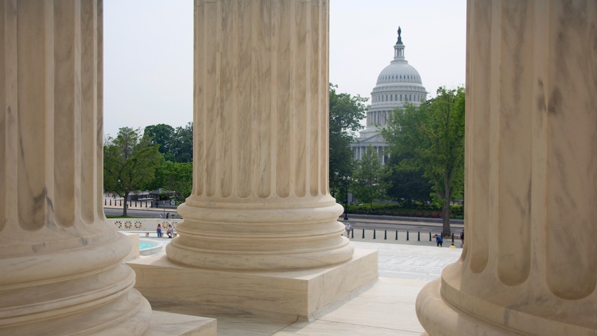 Building column in foreground, U.S. Capitol in background Building column in foreground, U.S. Capitol in background