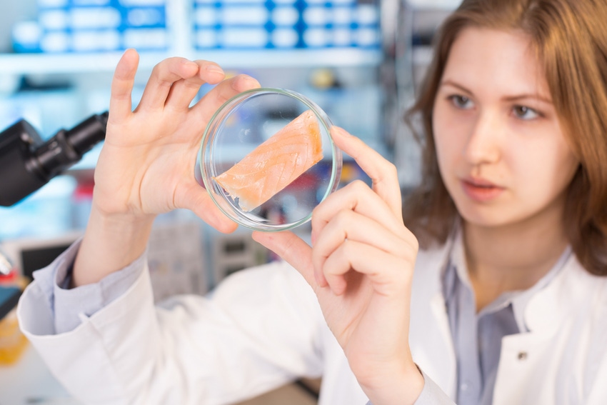 woman scientist with item in petri dish