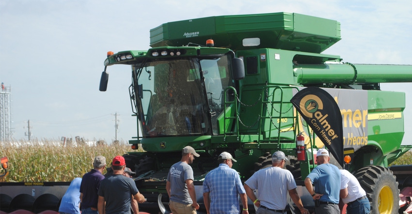 People inspecting combine