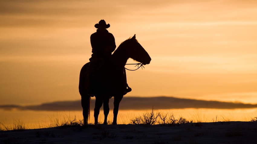 man on horseback at sunset