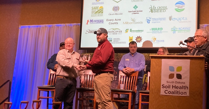 South Dakota Soil Health Coalition Chairman Levi Neuharth presents Anthony Bly with the Friend of Soil Health award 
